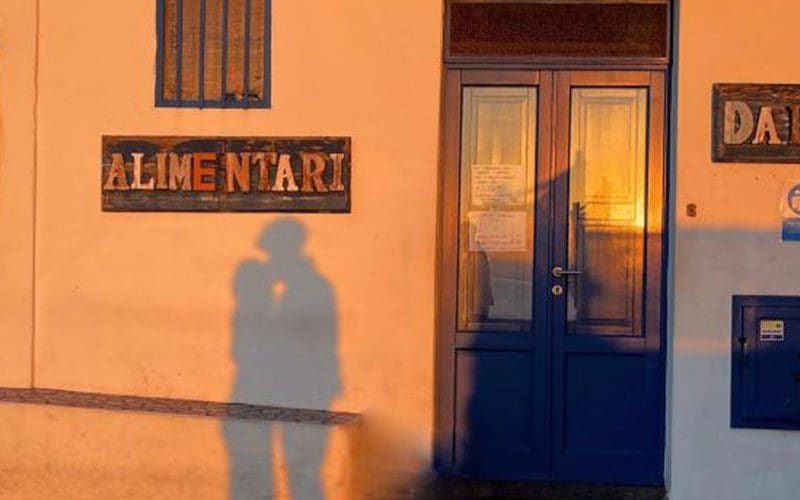 A shadow of a man and woman on the wall.