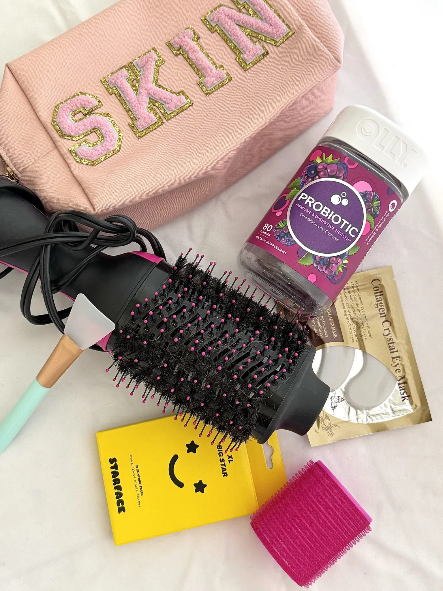 A bag of makeup, brush and other items on the table.