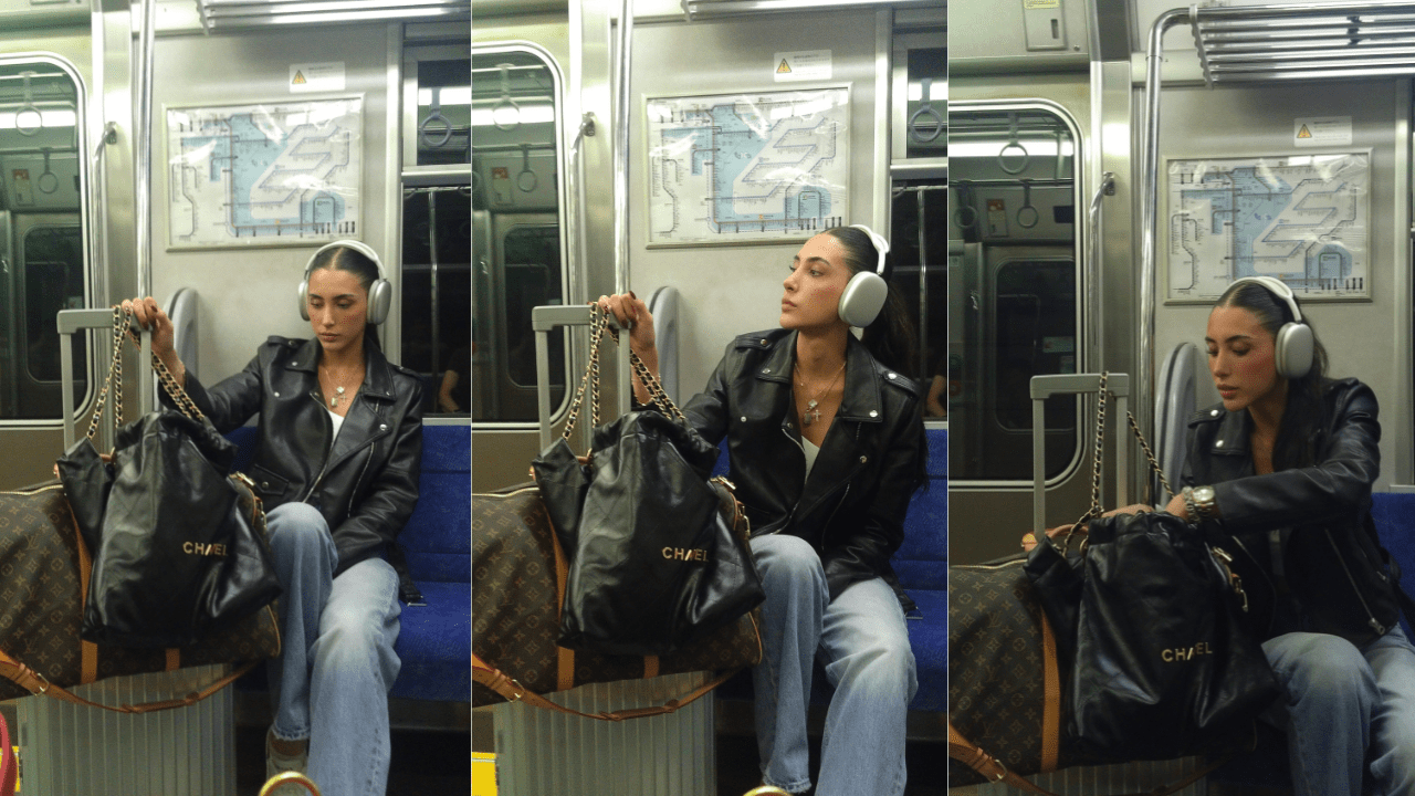 A man sitting on the subway with headphones around his ears.